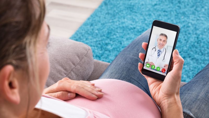 Pregnant lady making a video call to her doctor